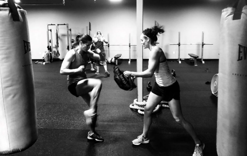 Two individuals boxing workout at Champion Fitness gym